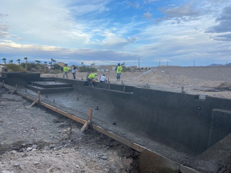 A group of construction workers are working on a large concrete structure.