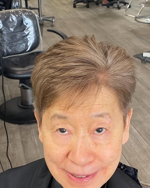 A close up of a woman 's face in a hair salon.