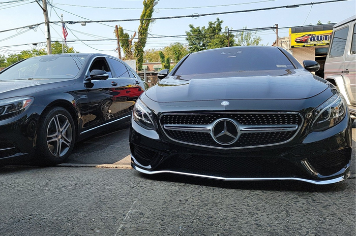 Two black Mercedes-Benz sedans parked on a lot | Kraft German Auto
