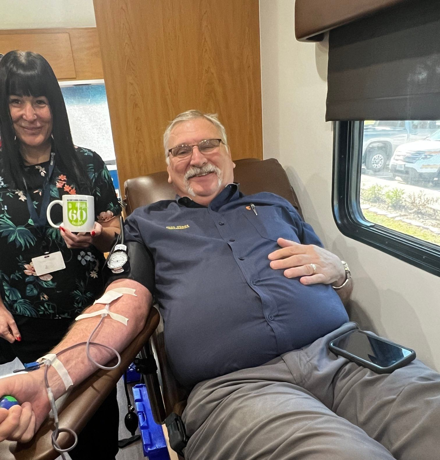 Man donating blood inside a mobile unit.