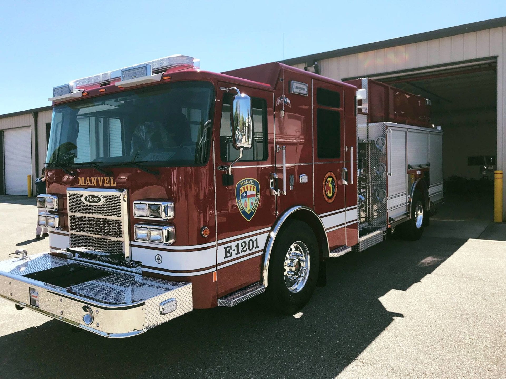 A red fire truck is parked in front of a building.