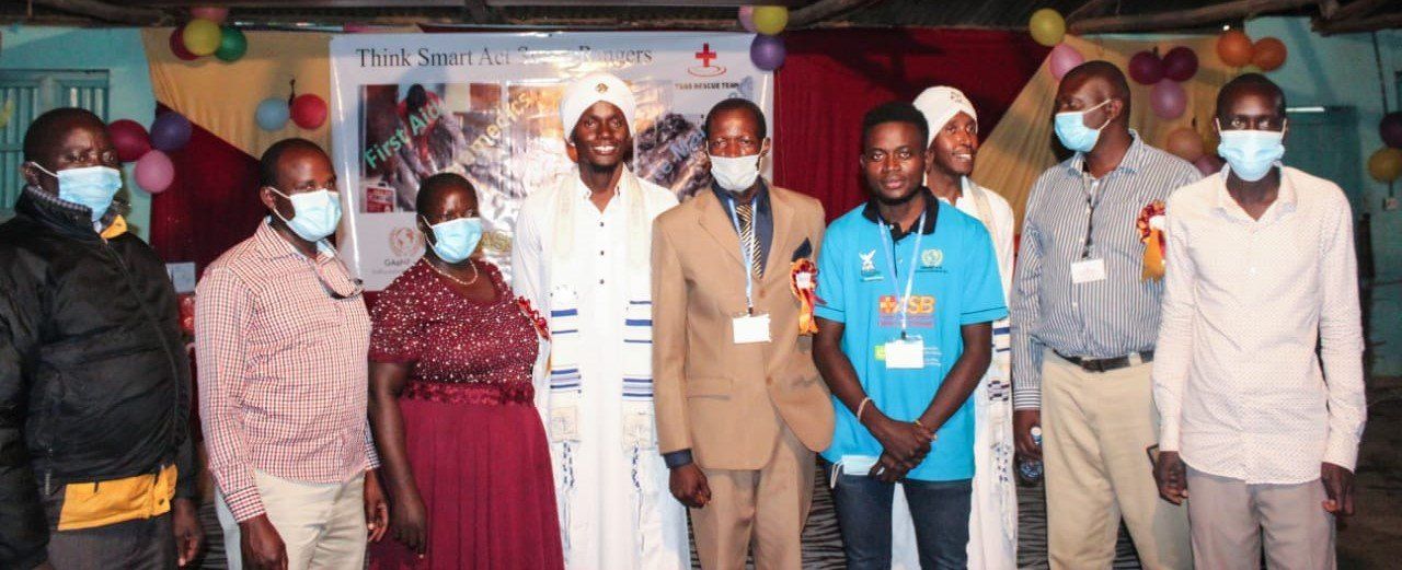 A group of people wearing face masks are posing for a picture.