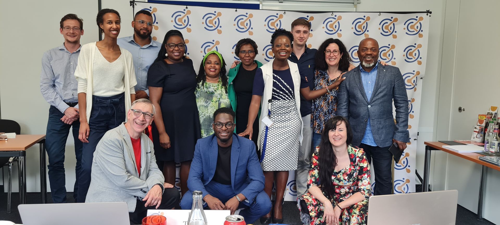 A group of people are posing for a picture in a room.