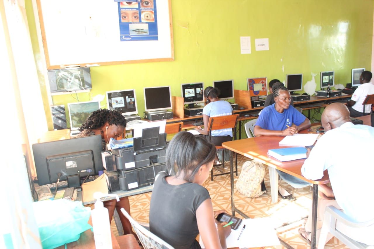 A group of people are working on computers in a room