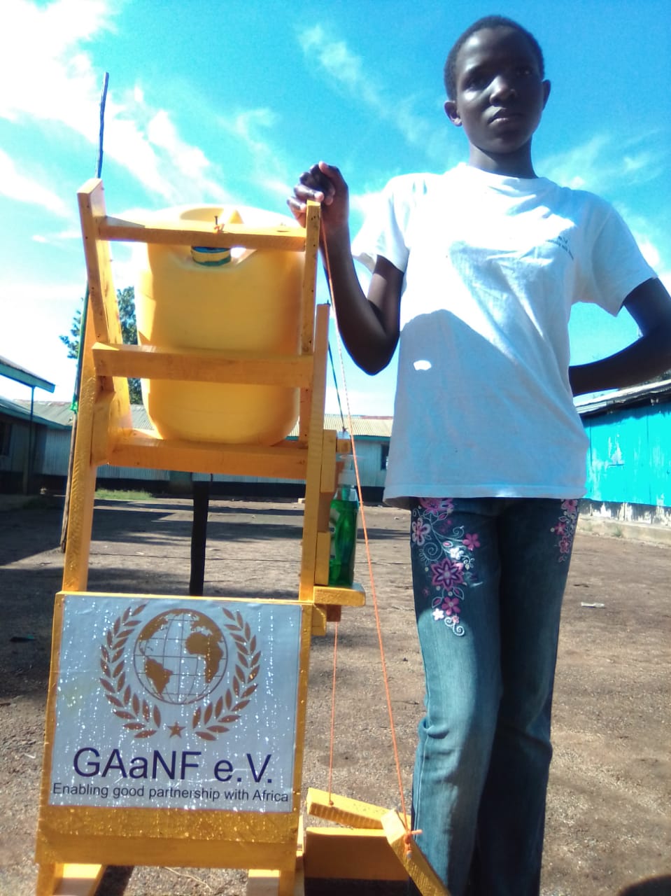 A person standing next to a sign that says gaanf e.v.