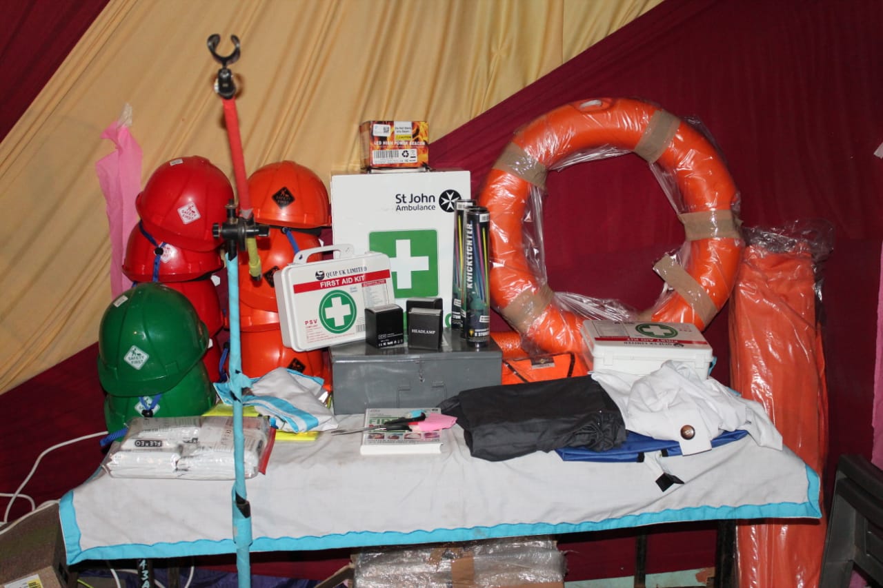 A table with a life preserver and a first aid kit on it
