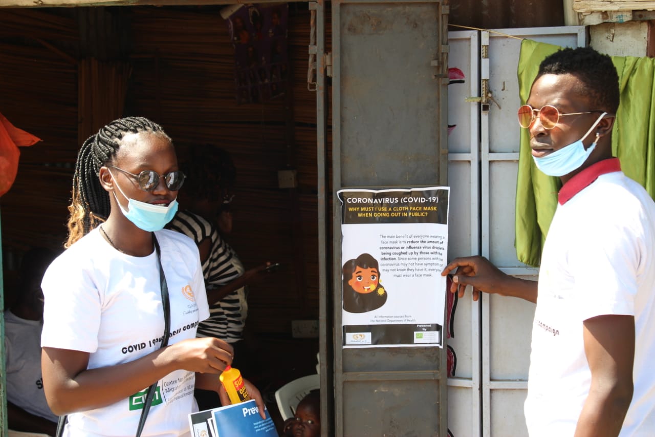 A man and a woman wearing masks are standing next to each other