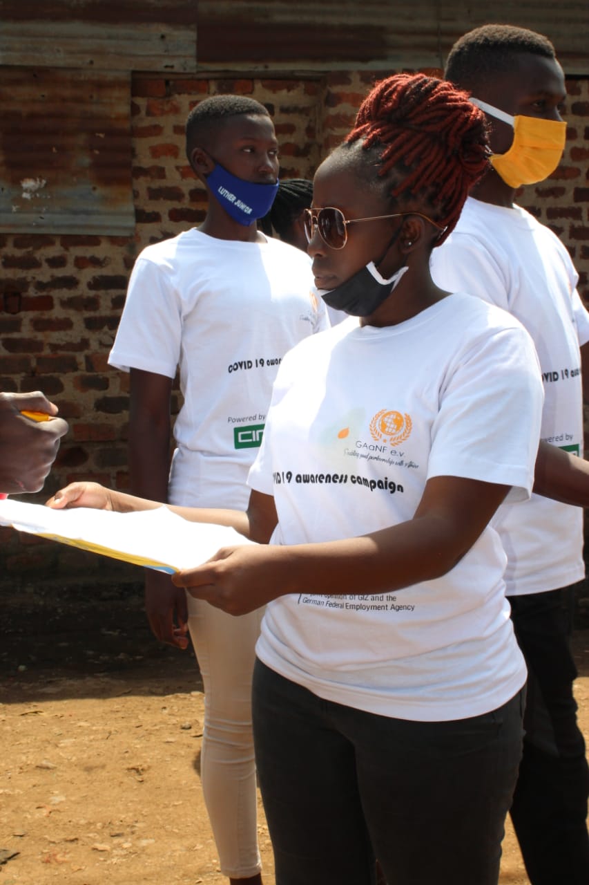 A group of people wearing face masks and white shirts