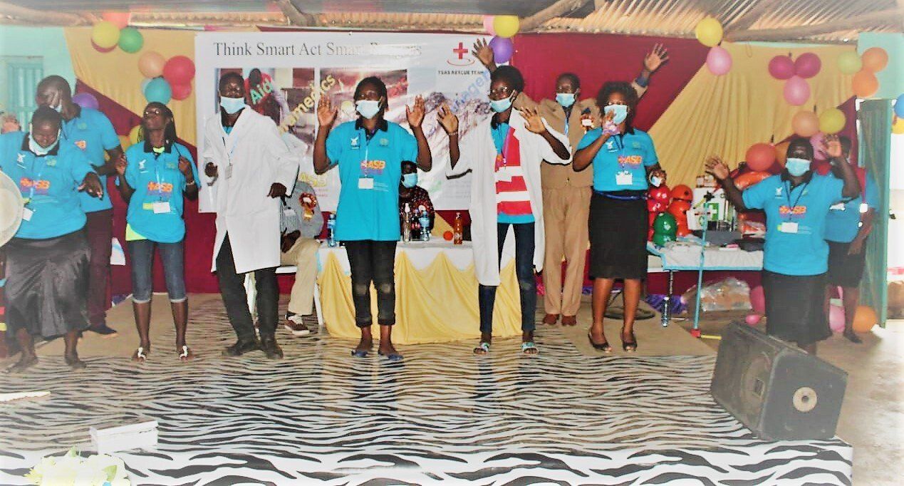 A group of people wearing masks are standing on a stage.