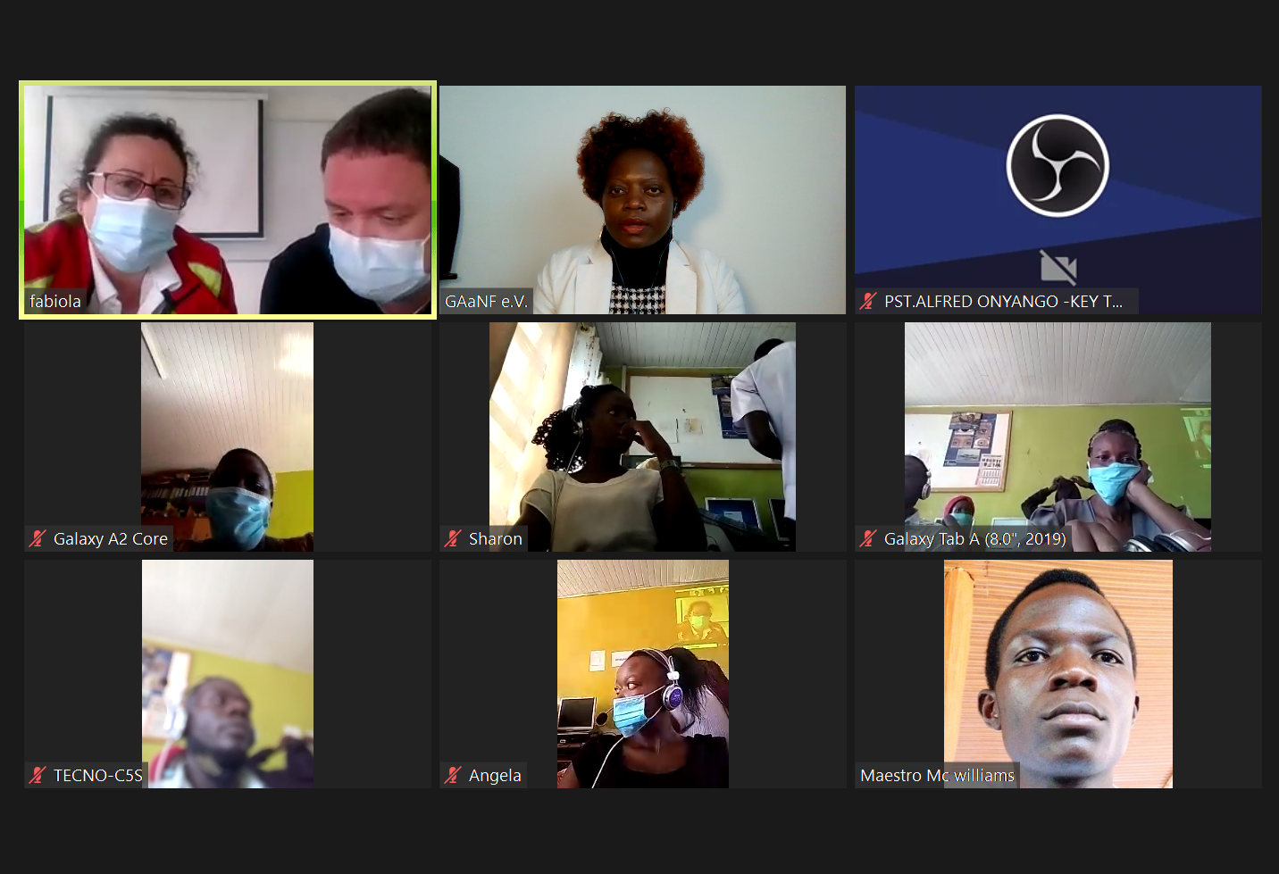 A group of people wearing face masks are on a video call.