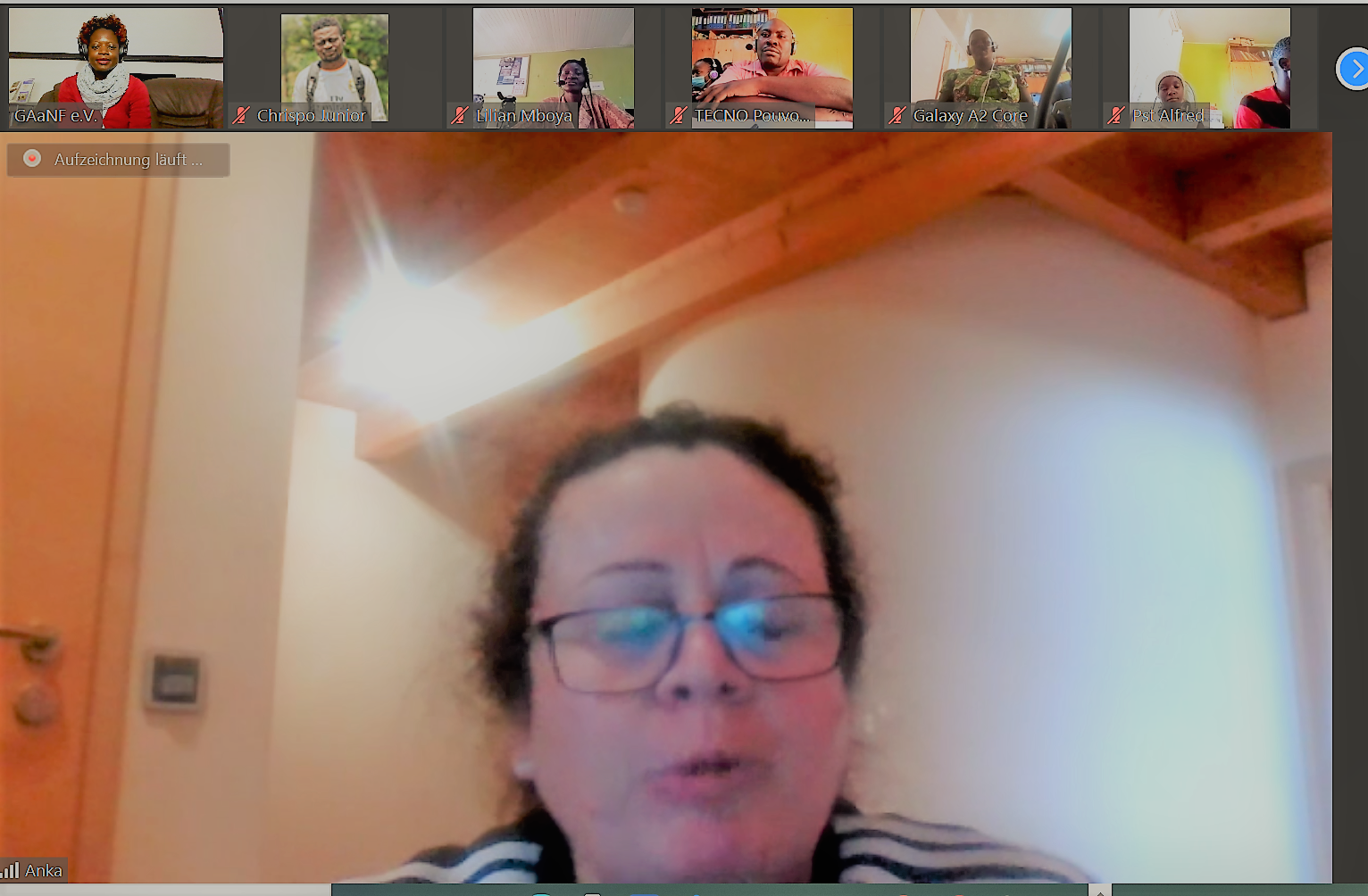 A woman wearing glasses is talking on a video call.