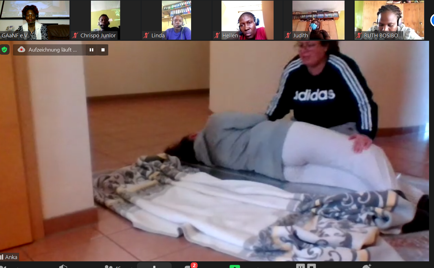 A man in an adidas shirt is giving a woman a massage