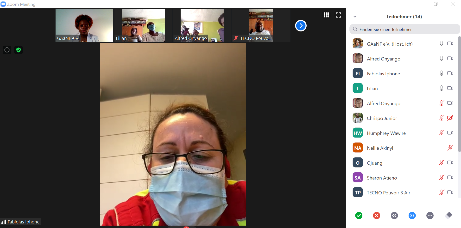A woman wearing a mask and glasses is on a video call.