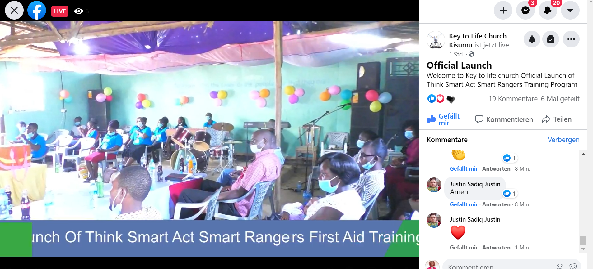 A group of people are sitting in a room with balloons on the ceiling.