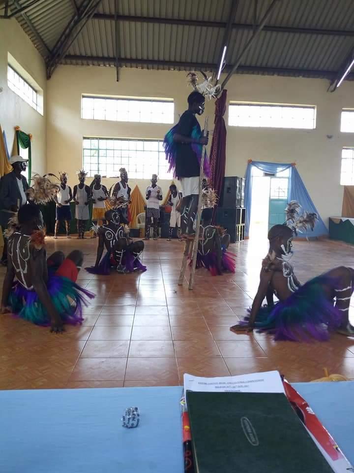 A group of people are dancing in a large room