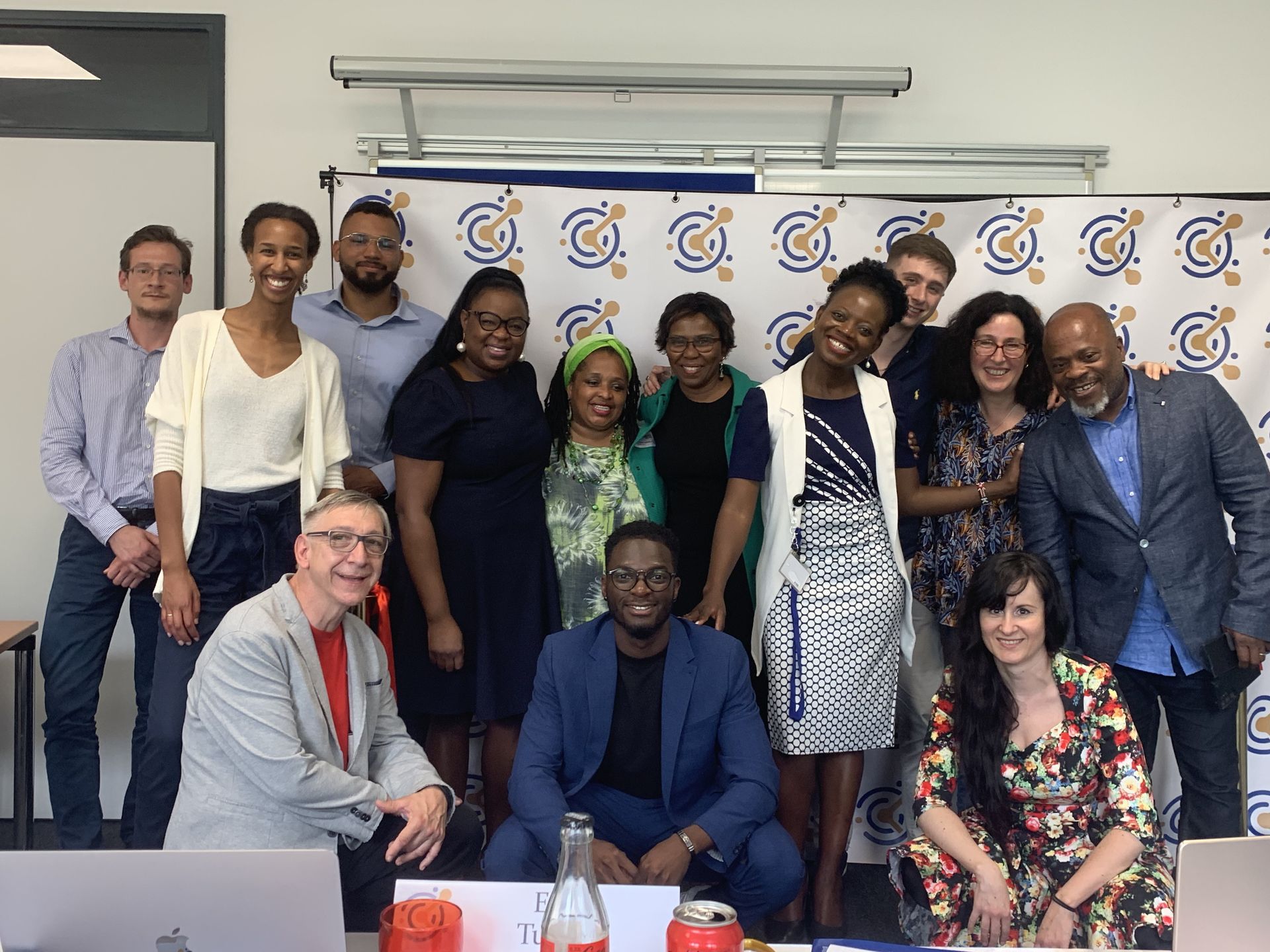 A group of people are posing for a picture in a room.