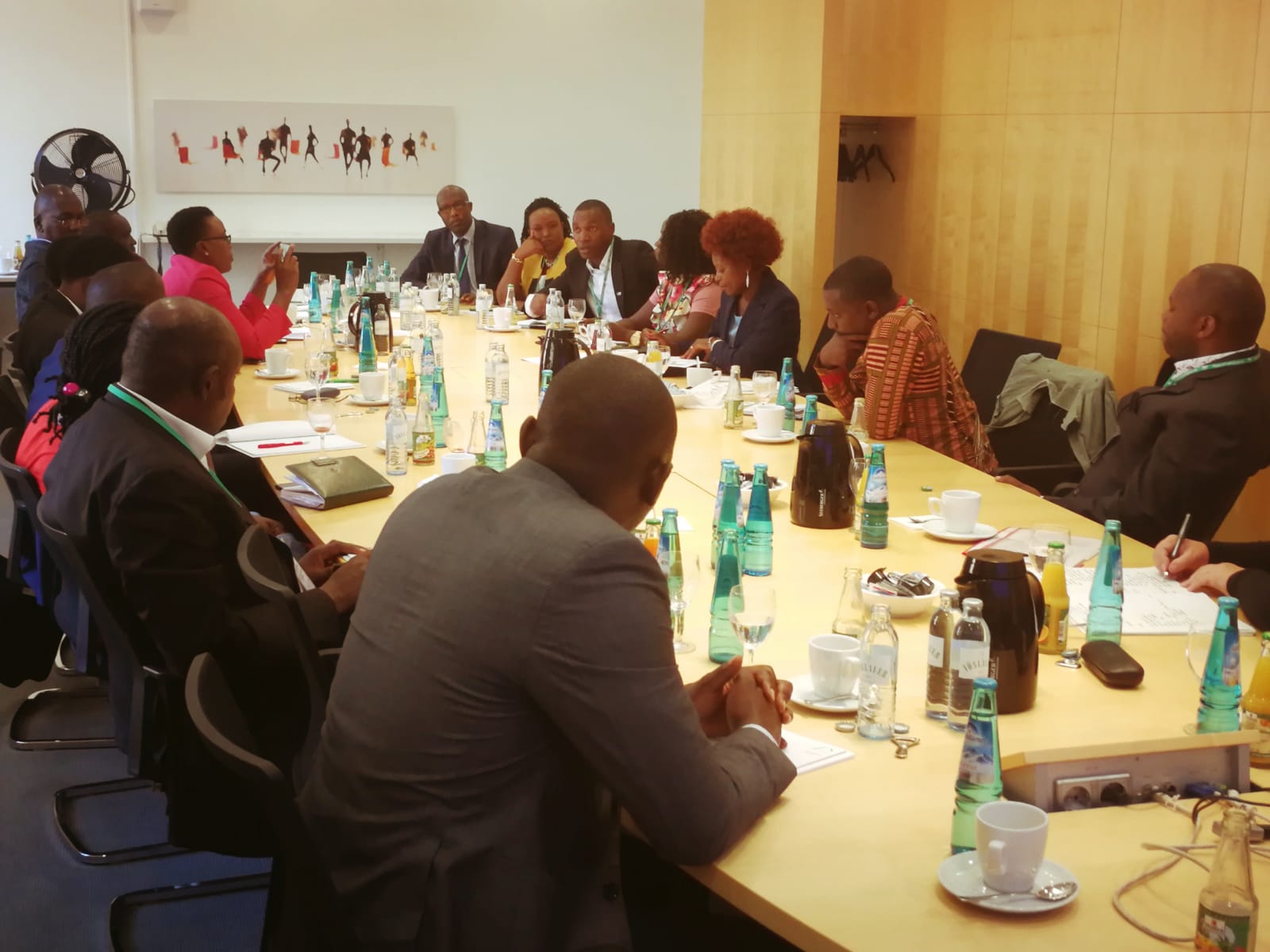 A group of people are sitting around a long table