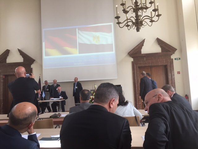 A group of people sitting in front of a projector screen