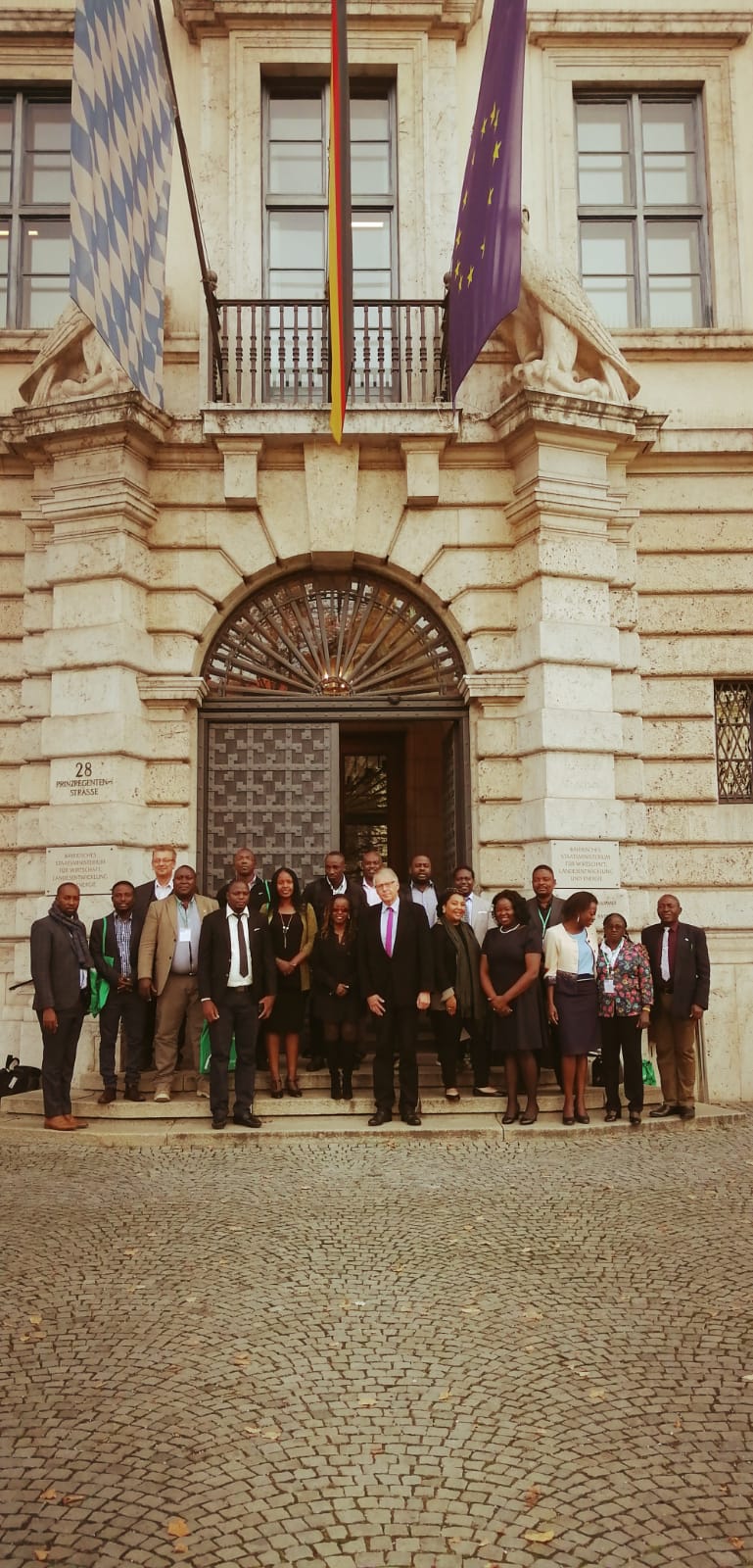 A group of people are standing in front of a building.