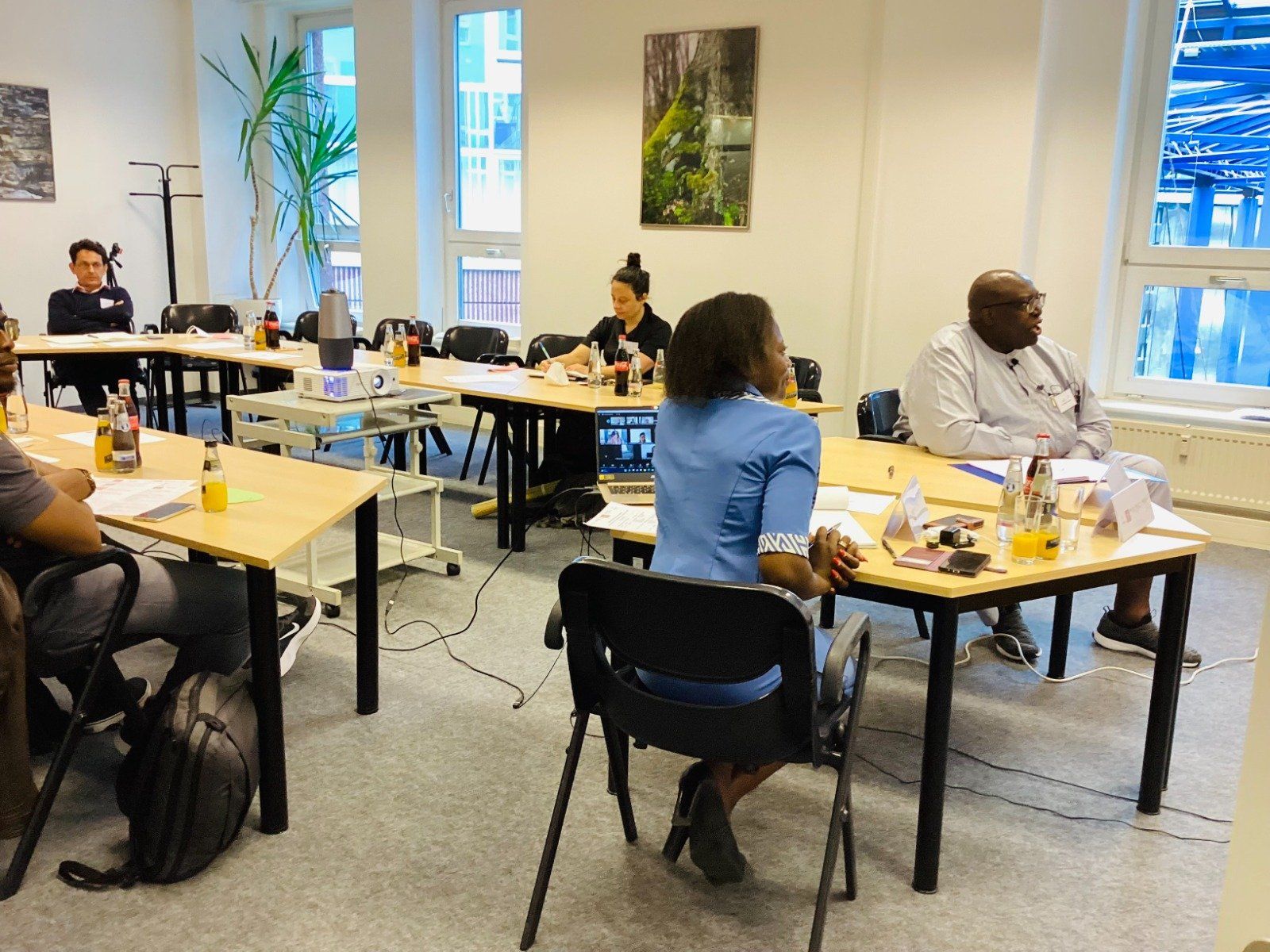 A group of people are sitting at tables in a room.