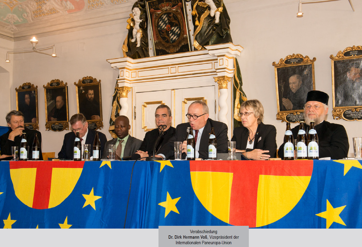 A group of people sitting at a table with bottles of wine