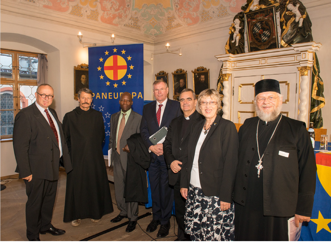 A group of people standing in front of a flag that says paneuropa