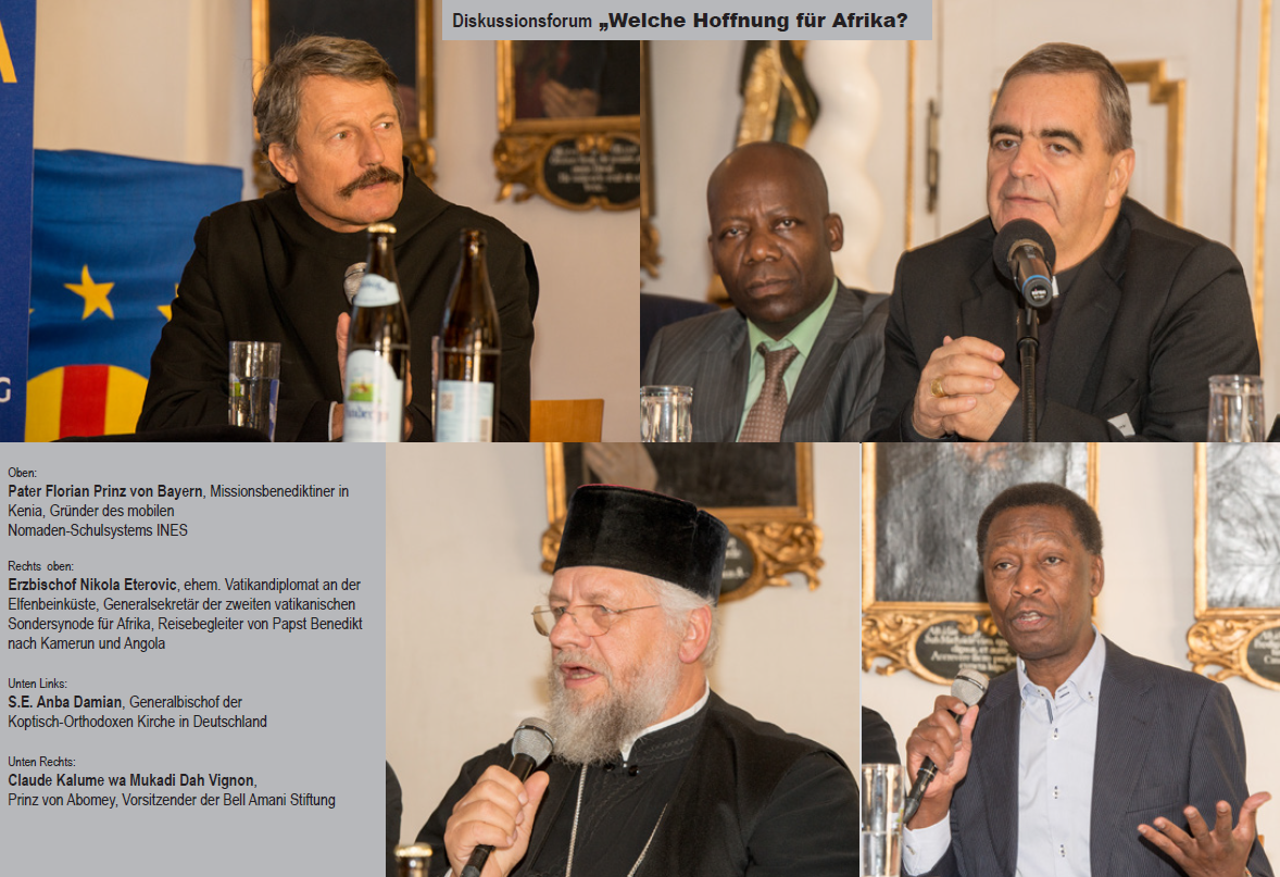 Four men are sitting at a table with microphones in their hands
