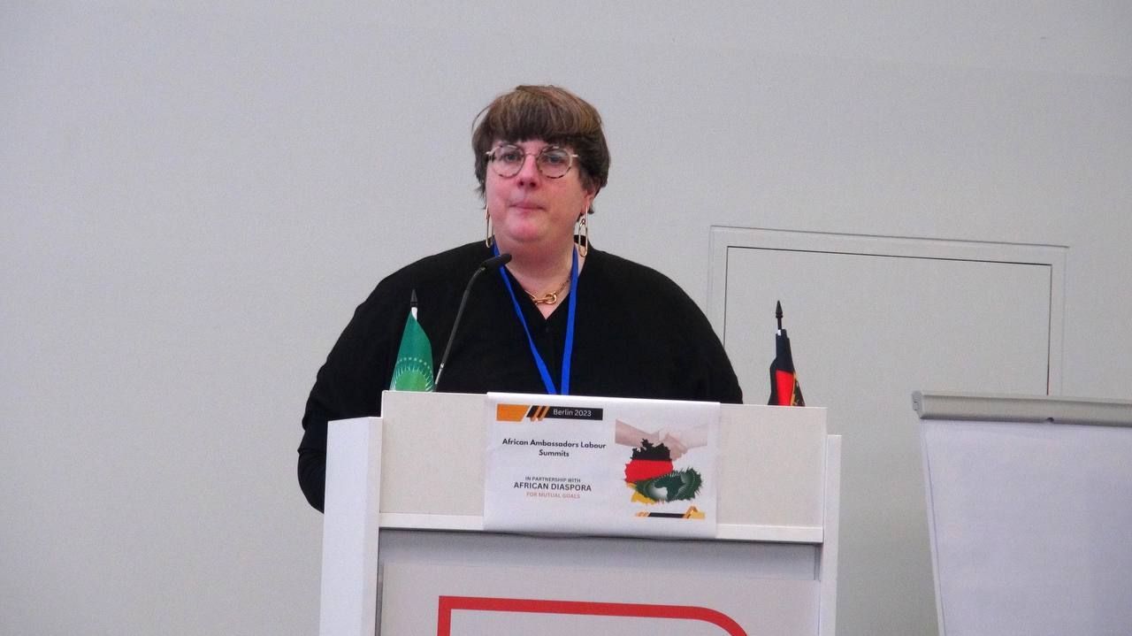 A woman is standing at a podium giving a speech
