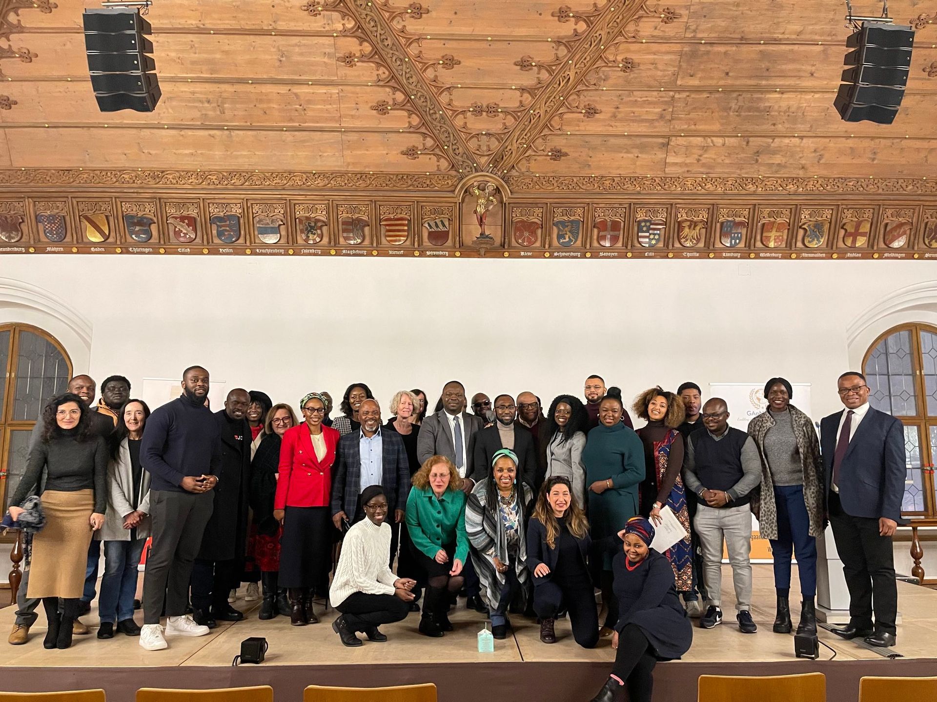 A large group of people are posing for a picture in a room.