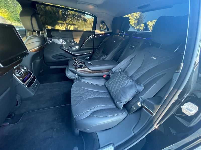 The back seat of a black mercedes benz s class is shown.