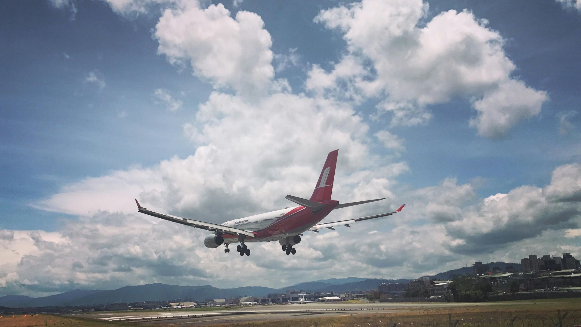 An airplane is taking off from an airport runway.