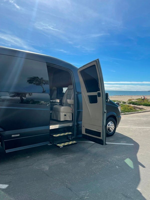 A van is parked in a parking lot with the door open.