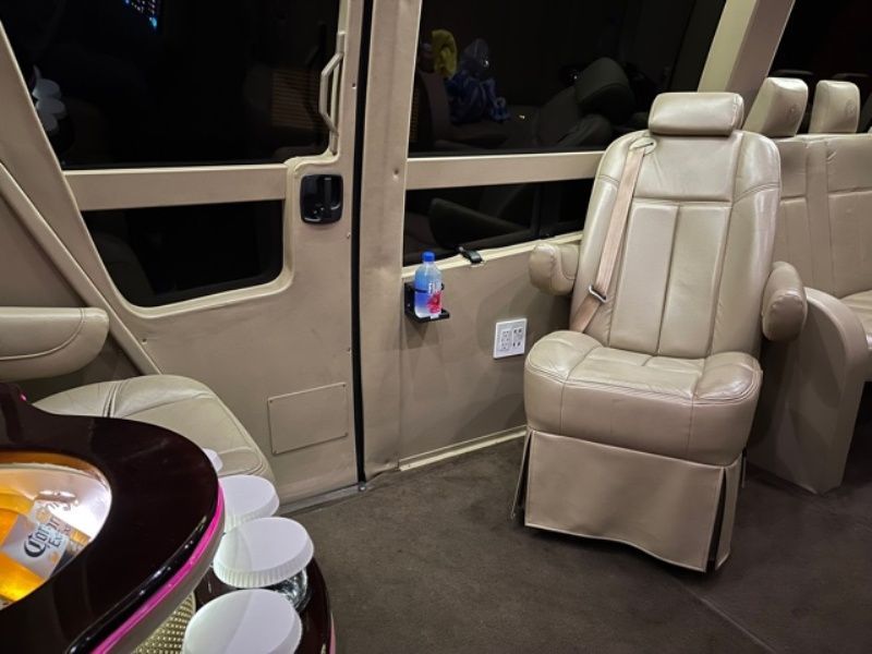 The inside of a van with a bottle of water on the door