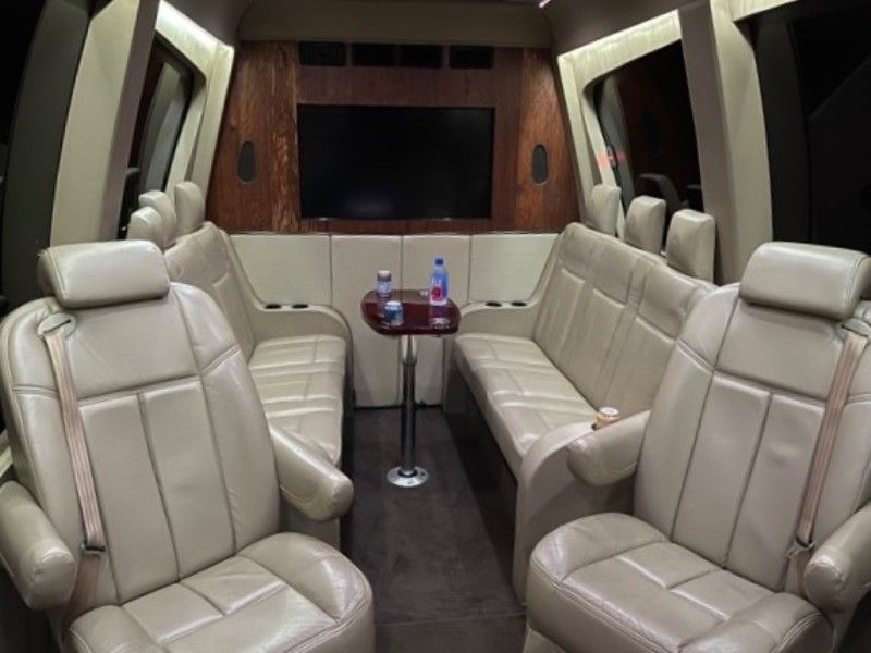 The inside of a car with a couch and a table