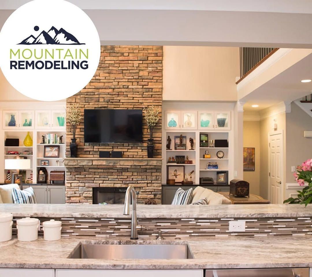 A kitchen with a mountain remodeling logo above it