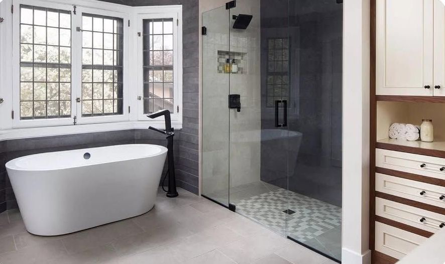 A bathroom with a bathtub and a walk in shower.