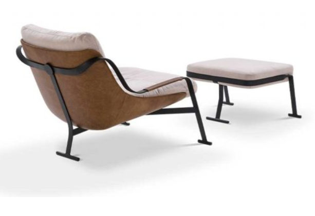 Poltrona e pufe em couro marrom com estrutura de metal preto e almofada bege.