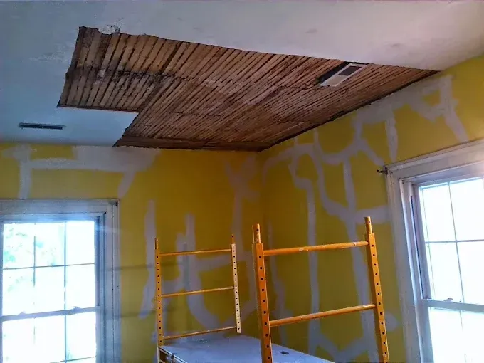 A room with yellow walls and a ladder in it