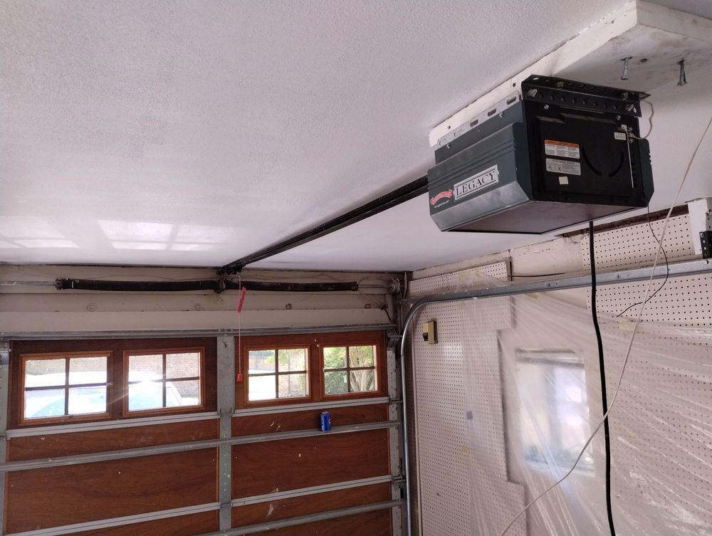 A garage door opener is hanging from the ceiling