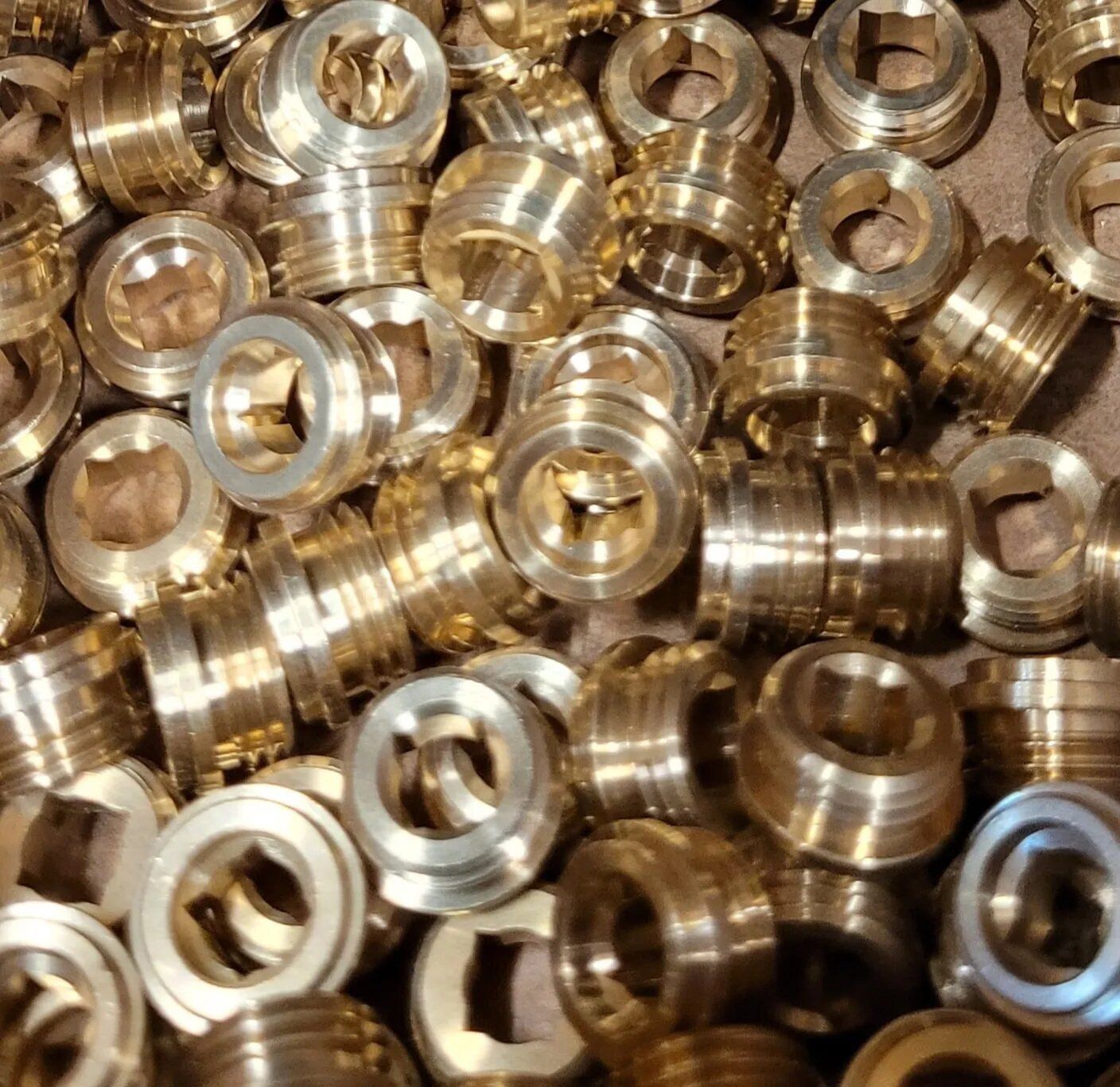 Pile of Brass Rings With Holes — Hattiesburg, MS — McElhaney Plumbing & Hardware Inc