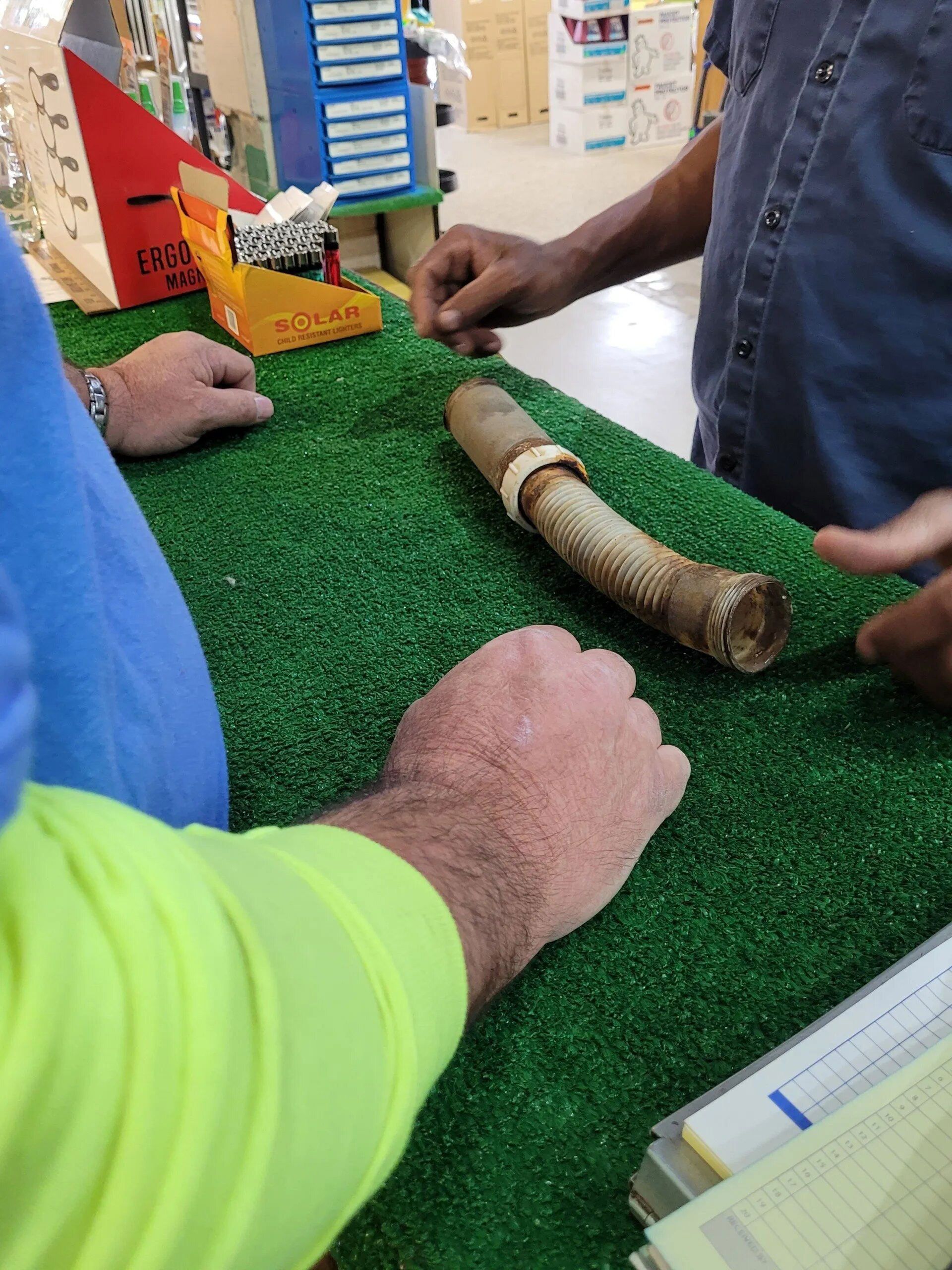 Two Men at a Counter — Hattiesburg, MS — McElhaney Plumbing & Hardware Inc