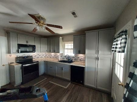 A living room with a couch , coffee table and rug.