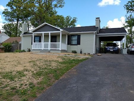 A house with a car parked in front of it