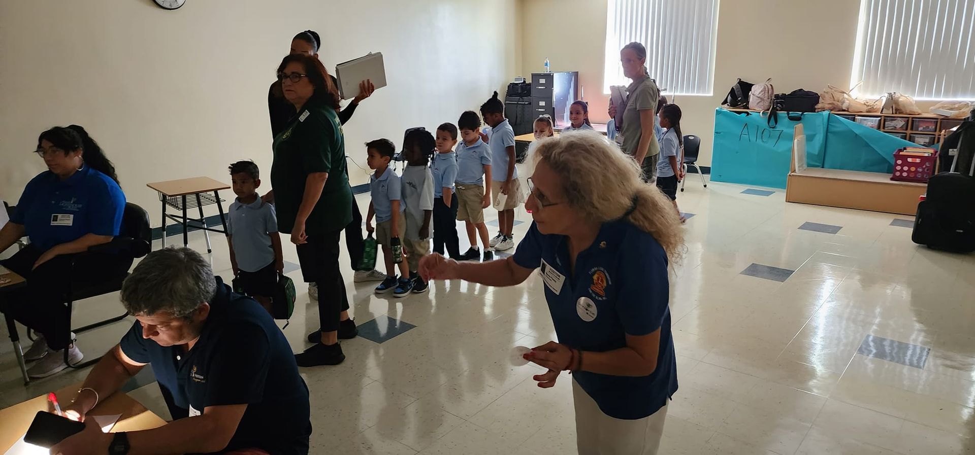 A group of people are standing in a room.