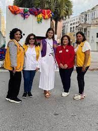 A group of women are standing next to each other on a street.