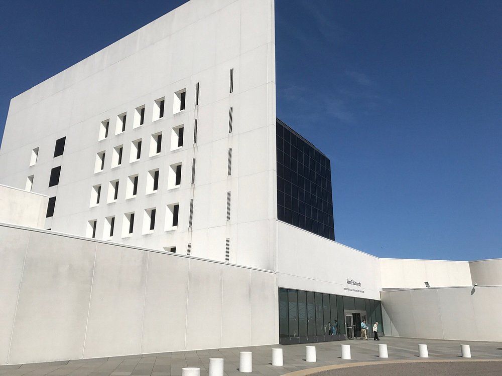 A large white building with a blue sky in the background