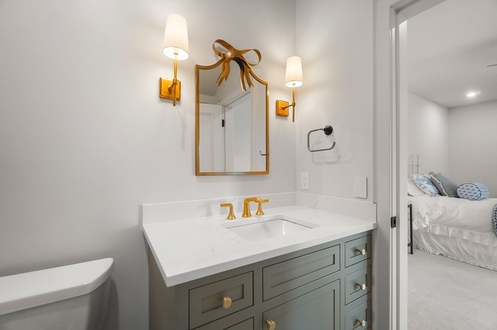 A bathroom with purple cabinets and a round mirror