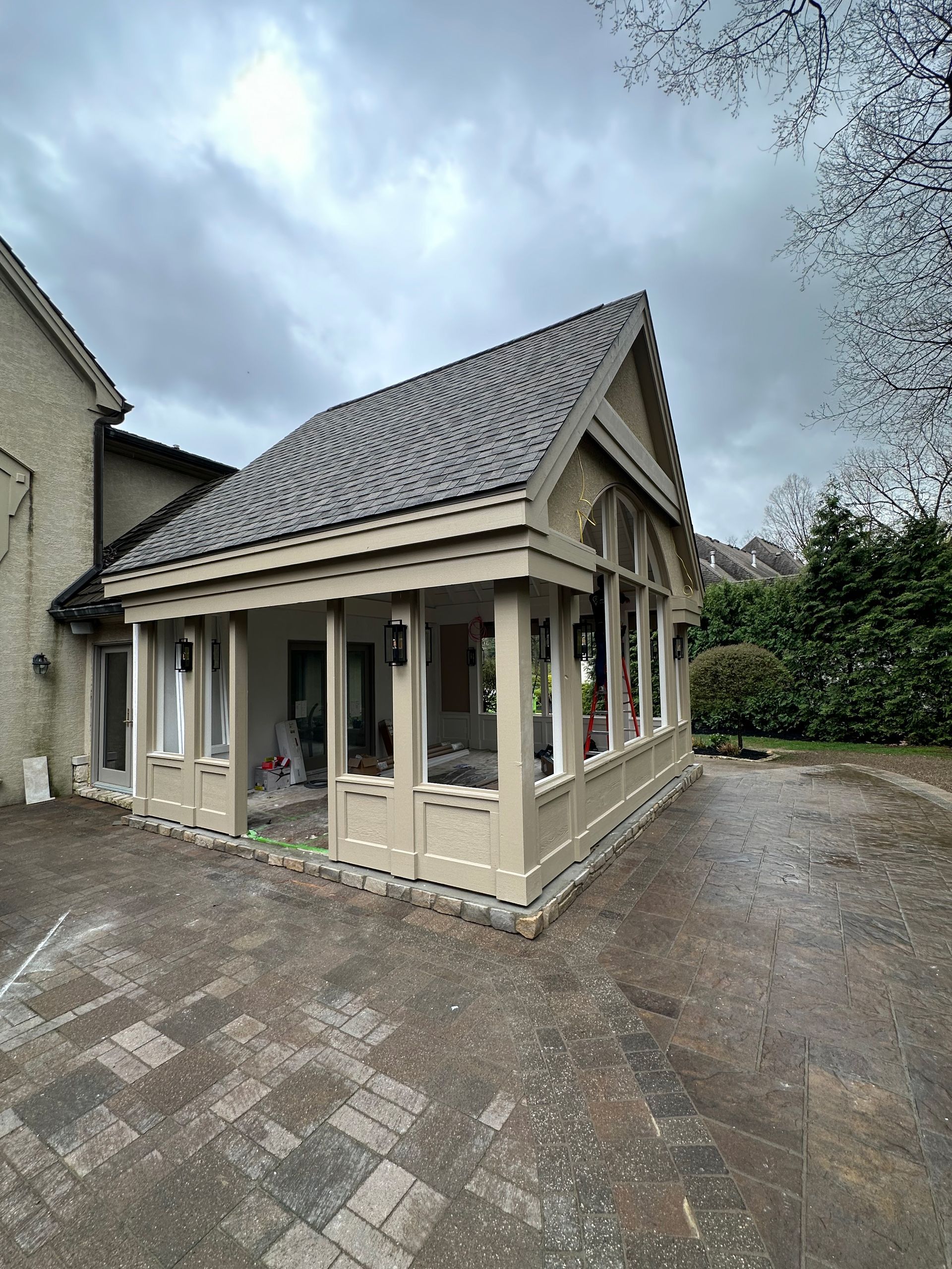 A kitchen with gray cabinets and a tiled floor