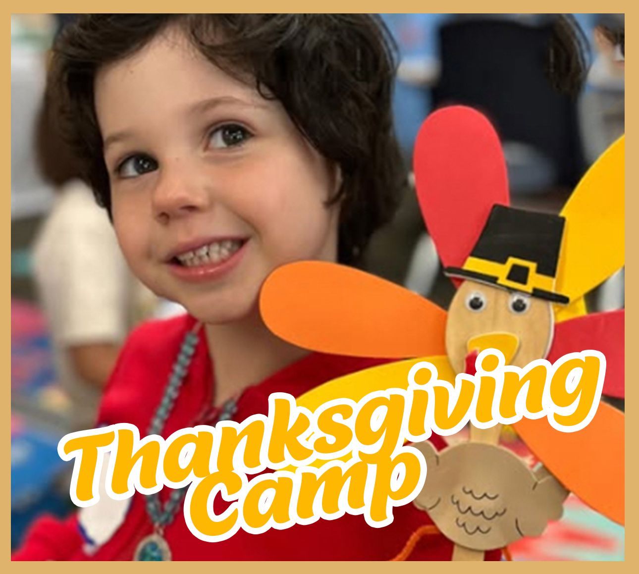 A young boy is holding a paper turkey with the words thanksgiving camp written on it
