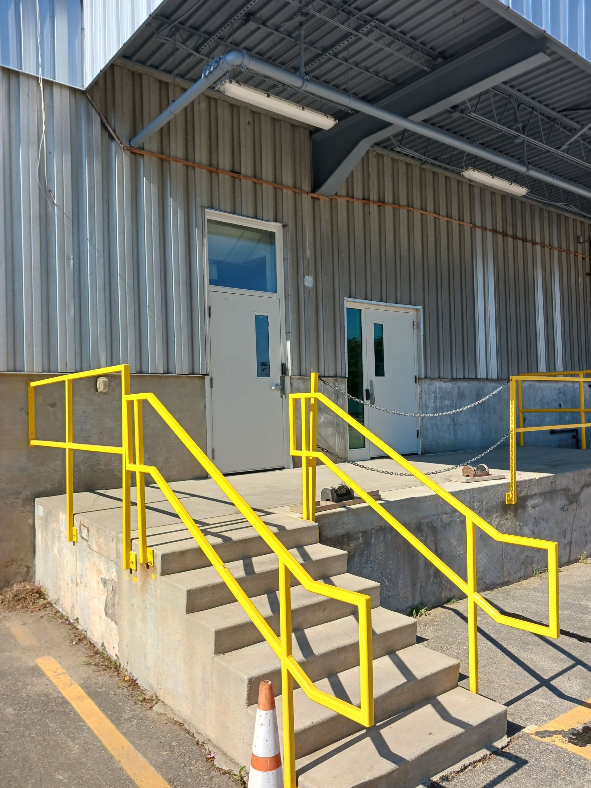 A building with stairs and a yellow railing